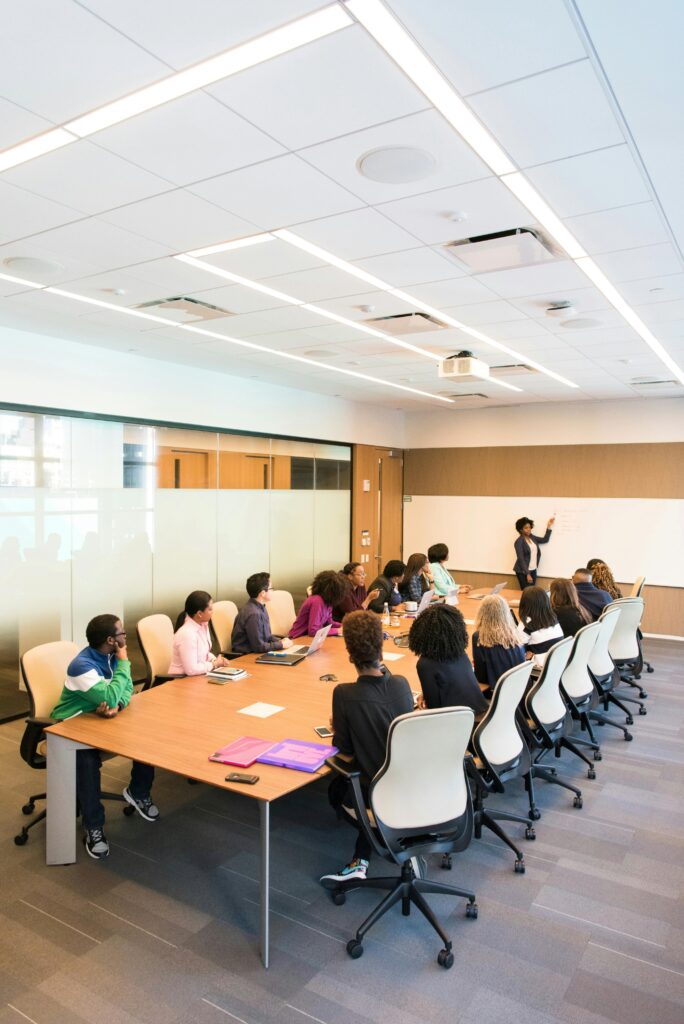 person-presenting-to-a-group-of-people-sat-at-a-board-table