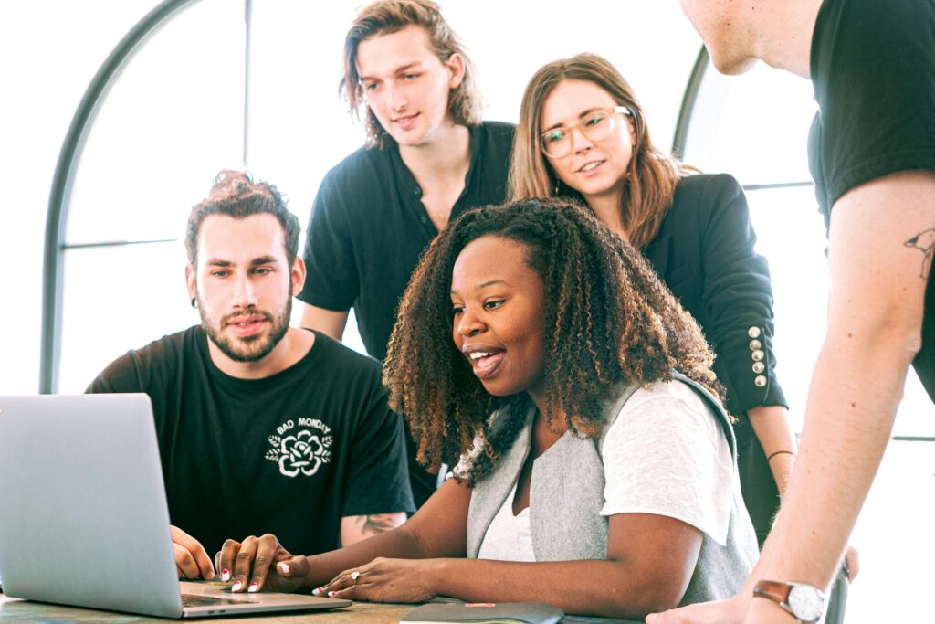 group-of-people-working-together-on-a-laptop