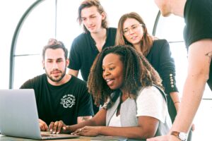 group-of-people-working-together-on-a-laptop