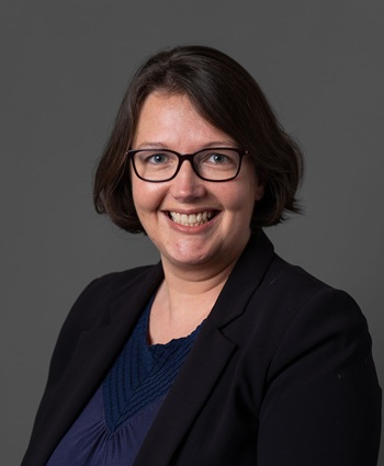 Headshot of person with grey background