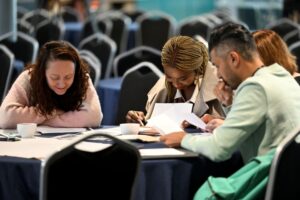 People sat around a table at VitaeCon2025 studying in a workshop. Image by Andrew Callaghan.