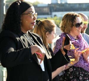 A group of women engage in a workshop activity outside involving post-it notes.  Image from #VitaeCon2025 by Andrew Callaghan.