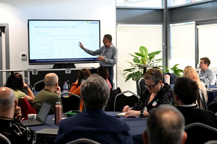 Robin Mellors-Bourne presenting What do researchers do? research in front of an audience of people in a workshop.  Image from #VitaeCon2025 by Andrew Callaghan.